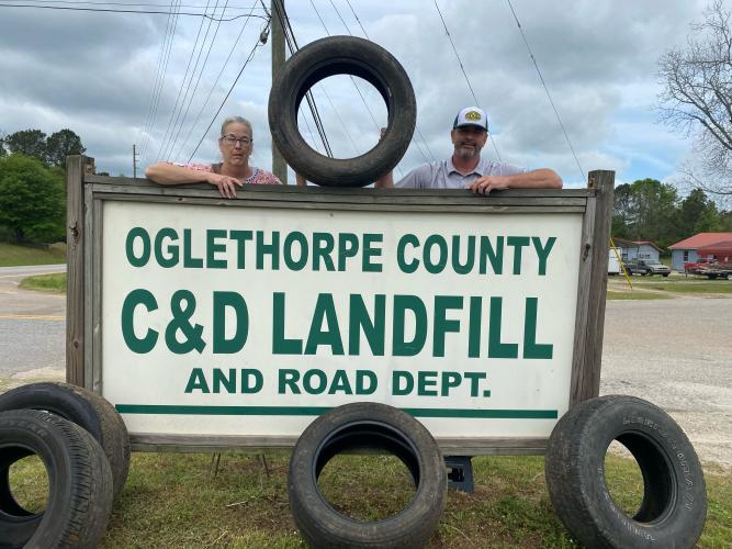 In celebration of Earth Day, the Oglethorpe County  Landfill is hosting an opportunity for local residents  to dispose of unwanted passenger-vehicle tires.  Scale  house operator Heidi Tidwell, left, and public works di- rector Adam Nation, right, pose to promote this Friday  (8 a.m. to 4:30 p.m.) and Saturday’s (8-11:30 a.m.) event  at 882 Athens Road in Crawford. (Dink Nesmith/The Oglethorpe Echo)