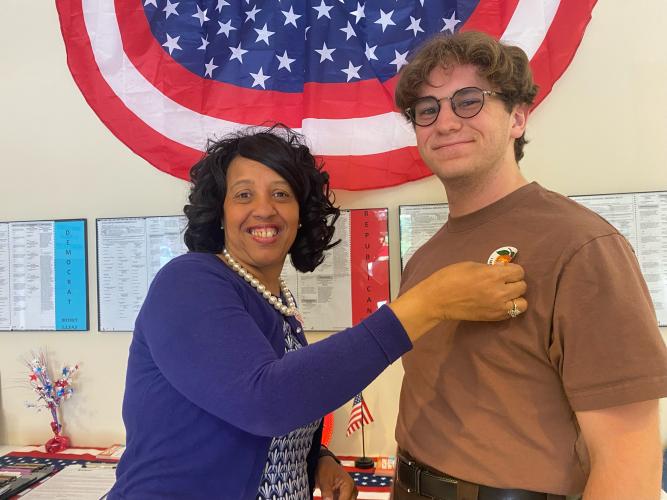 Clay Reece, 18, a senior at Oglethorpe County High School, receives his sticker from election supervisor Marilyn Huff-Waller on Tuesday after voting for the first time. (Photo/Dink NeSmith)