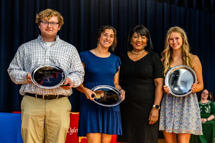 OCHS principal Susie Johnson (third from left), stands with salutatorian Myles Oliver (from left), valedictorian Elizabeth Palmer and honorarian Ella Mason. (Photo/Jack Casey)
