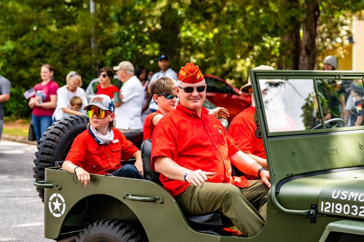 Parade participants enjoy their ride in a U.S. military Jeep during the Marigold Festival parade on Saturday. The Marigold Festival was first held in 1971. (Photo/Jack Casey)