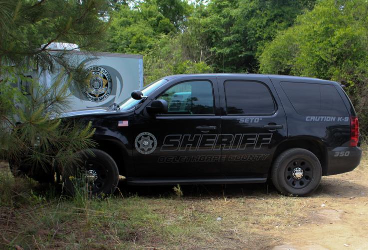 A Oglethorpe County Sheriff’s Office car parked off of Rocky Drive during the recent search of two quarries for the remains of murder victim Jimmy Anglin. (Photo/Caitlin Farmer)