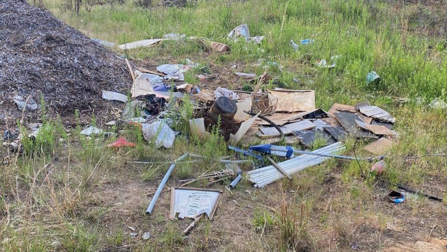 Trash and debris litter the area around Rocky Drive in the northeast part of the county. (Photo/Dink NeSmith)
