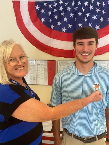 OCHS senior Zachery Franken, 19, who voted for the first time on Tuesday, receives his sticker from Elaine McGarity. (Photo/Dink NeSmith)