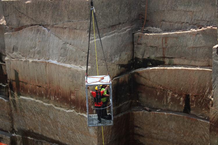 Searchers are lowered into one of the abandoned granite quarries that was drained in the search for murder victim Jimmy Anglin's remains. (Photo/Caitlin Farmer)