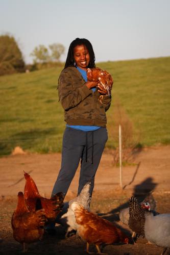 Tamita Brown holds her favorite chicken Honey, which is blind in one eye and smaller than the other chickens. Honey is the only named bird on the farm and will often hang around Brown while she does chores. (Photo/Basil Terhune for The Oglethorpe Echo)