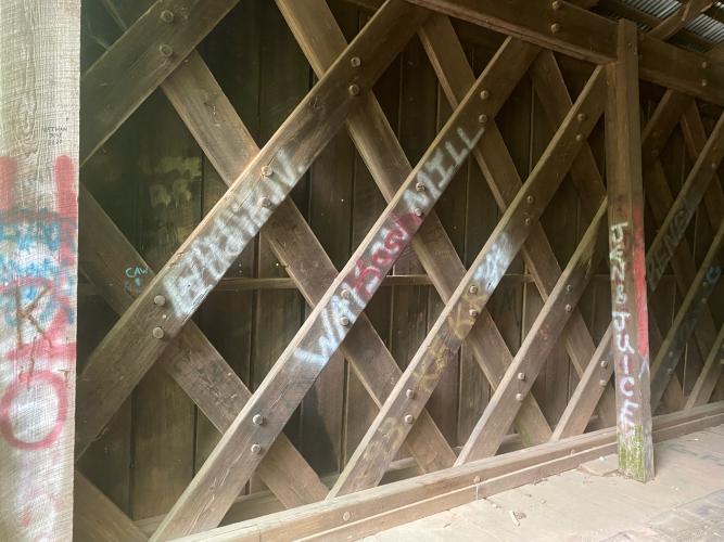 The architectural nuances of Howard’s Covered Bridge, which was built in 1904-05, are now defaced by graffiti. (Photo/Dink NeSmith)