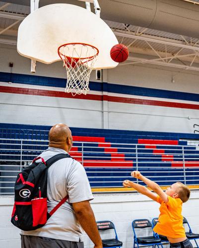 OCHS boys basketball coach Larry Brown, a former UGA football and basketball player, works with camper Daniel Utley. (Photo/Jack Casey)