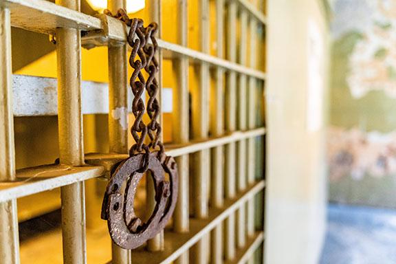 Rusty handcuffs dangle from one of the cells at the old Oglethorpe County Jail, which was built in 1879 and became a museum in 2012. (Photo/Jack Casey)