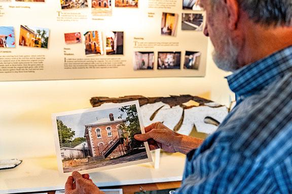 Thomas Gresham looks at a photo taken of the exterior of the jail before it was painted and restored. It was opened as a museum in 2012. (Photo/Jack Casey)