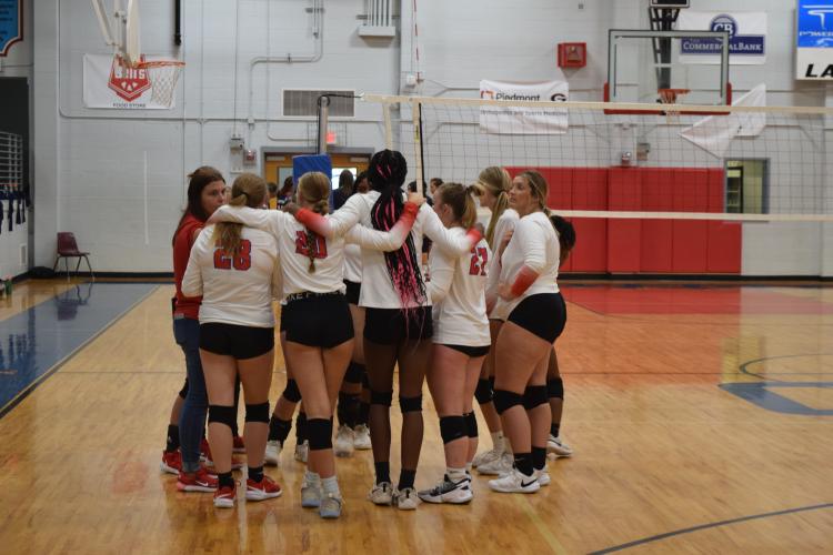 Oglethorpe County players gather around coach Kate Shealy during the Patriots’ win over Putnam County. They host matches on Thursday, Aug. 18, beginning at 5 p.m. (Photo/Wade Cheek)