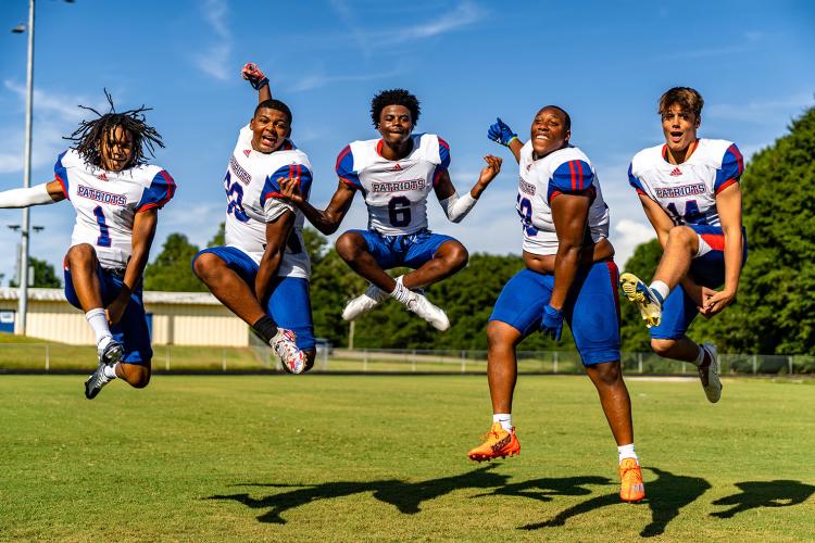 Oglethorpe County football players Jordan Johnson (1), Jayland Richardson (30), Darius Heard (6), K.B. Bonds (58) and Ashton Sexton (14) appear to be jumping for joy for the start of the 2022 high school football season. The Patriots open at home against East Jackson at 7:30 p.m. Friday. (Photo/Jack Casey)