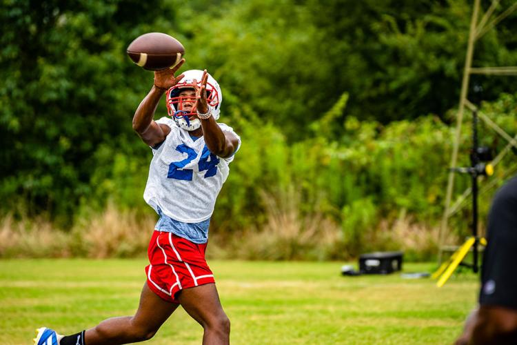 Tristan Anderson snags a pass during football practice this week as the Patriots prepare for their first game on Aug. 19. (Photo/Jack Casey)
