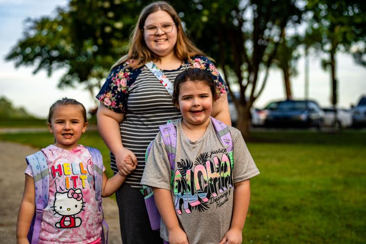 Aubrie Miller walks Natalie Miller, left, who is in kindergarten, and Briella Miller, who is in first grade, into Oglethorpe County Primary School on their first day of school. (Photo/Jack Casey)