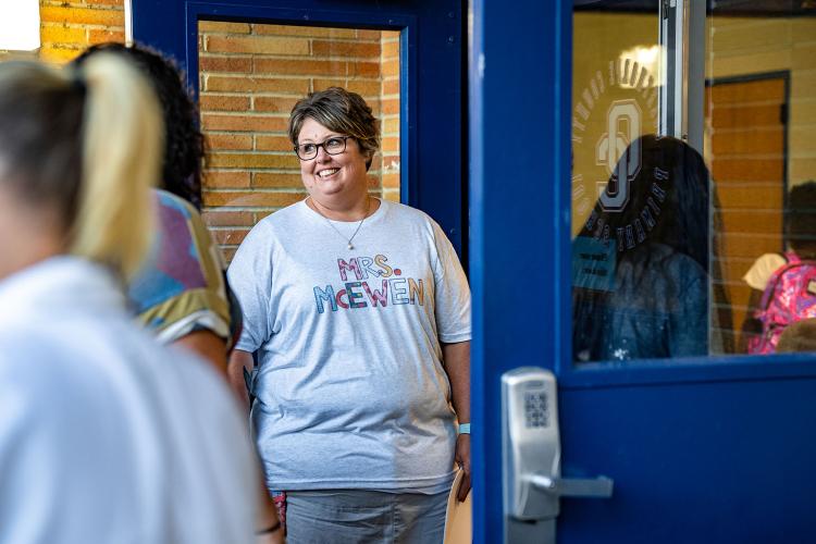 Susan McEwen, a paraprofessional at Oglethorpe County Primary School, greets students as they head inside for their first day of school on Tuesday. (Photo/Jack Casey)