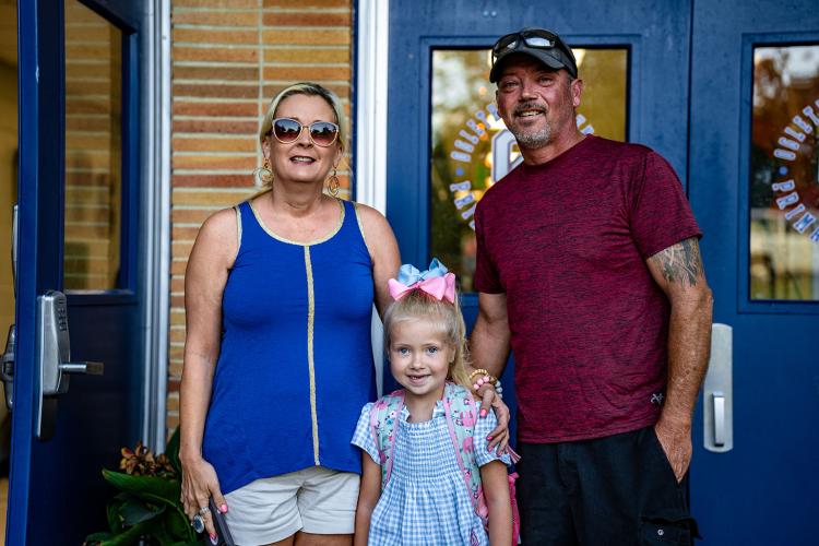Lynn Streetman, who is in first grade, and her parents Johnny and Lexi Streetman are all smiles before they head into Oglethorpe County Primary School on Tuesday. (Photo/Jack Casey)