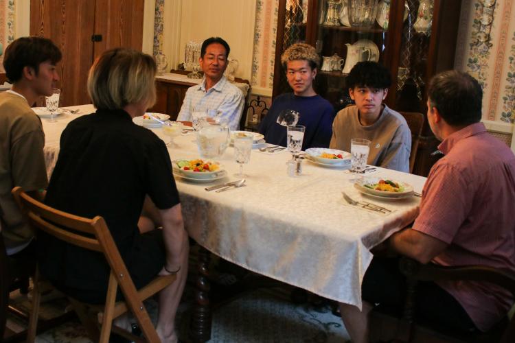 Hidekatsu Sakamoto, left, and students Kanata Suami, Yokomaku Shun and Yokoyama Kosei chat with Wesley Gilson at dinner. (Aisha Schulz/The Oglethorpe Echo)