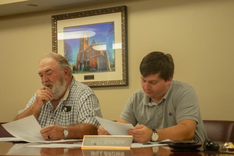 (KATIE TUCKER/THE OGLETHORPE ECHO) Commissioners Phil Sanders, left, and Will Brown, look over notes at the monthly commission meeting on Monday night.