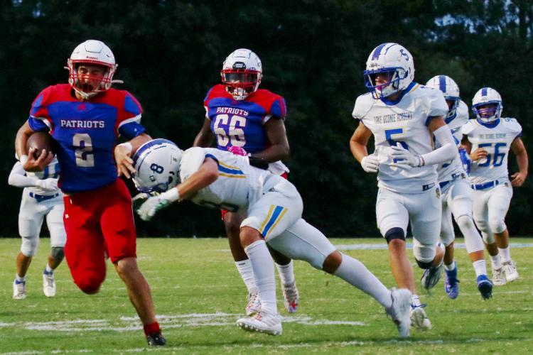 Oglethorpe County’s Jake Turner brushes off Lake Oconee Academy’s Cameron Kelley on his way to rushing for 113 yards on only 13 carries in the Patriots’ 42-0 victory earlier this month. (Alyssa Ginn/The Oglethorpe Echo)
