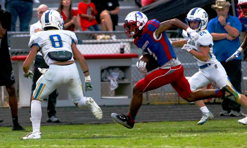 OCHS running back Elijah Hood makes a break past Lake Oconee Academy defenders Cameron Kelley, left, and Jaxon Herrin in the Patriots’ 42-0 victory. Hood finished with 73 yards rushing on six attempts. (AISHA SCHULZ/THE OGLETHORPE ECHO)