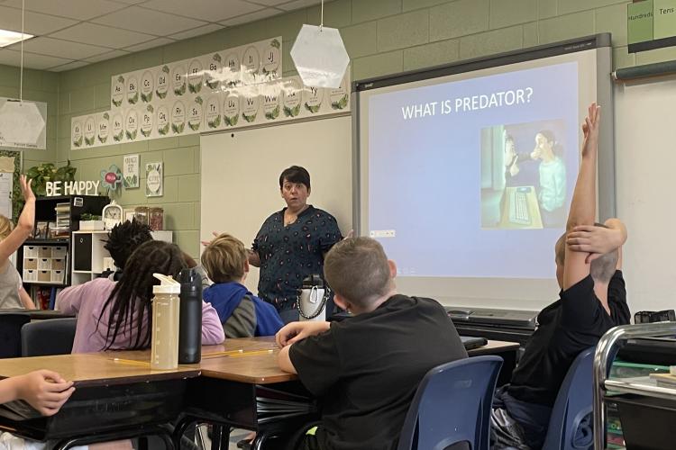 (KENNEDY LEWIS/ THE OGLETHORPE ECHO) Fifth-grade students at Oglethorpe County Elementary School listen to Sgt. Samantha Mathe talk about internet safety as a part of the C.H.A.M.P.S. program.