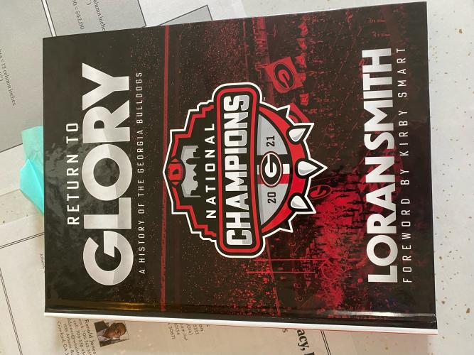 (Dink NeSmith/The Oglethorpe Echo) Loran Smith’s latest book, titled “Return to GLORY: A History of the Georgia Bulldogs,” includes the 2021 national title season.