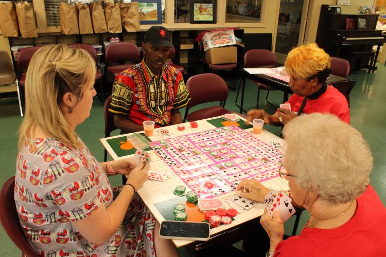 (Andrea Gutierrez/The Oglethorpe Echo) Director Corie Robinson, left, plays a card game with Gary Armstrong, top, Roz Echols, right, and Gwen Kelley, bottom, at the Oglethorpe Senior Center last week. The center provides activities, meals and transportation for the county’s seniors.