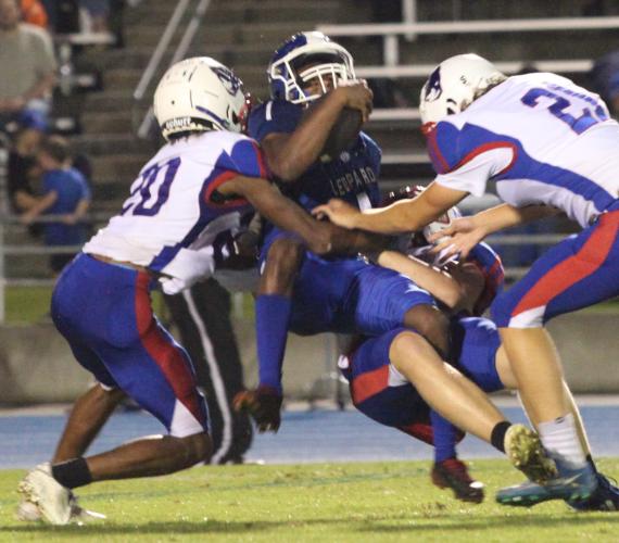 (Donny Faust/For The Oglethorpe Echo) Michael Fleming, Joseph Turner and LT Faust gang up to tackle a Banks County ball carrier. Oglethorpe County scored first, but lost 21-7 on Friday.