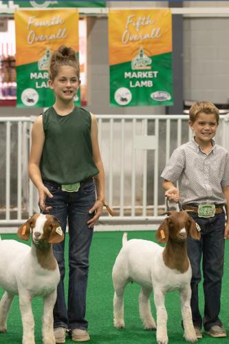 Naomi (left) and Cam McPeake pose with their award winning animals on Saturday, Oct. 8, 2022 at the Georgia National Fair in Perry, Georgia. (Photo/Katie Tucker)