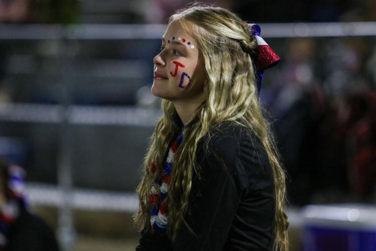 OCHS cheerleader Khali McCormack wears Jacob Dake’s initials painted on her cheek for the second football game in a row since his accident, Oglethorpe County high school, Sept. 29, 2022. (Aisha Shulz/The Oglethorpe Echo)