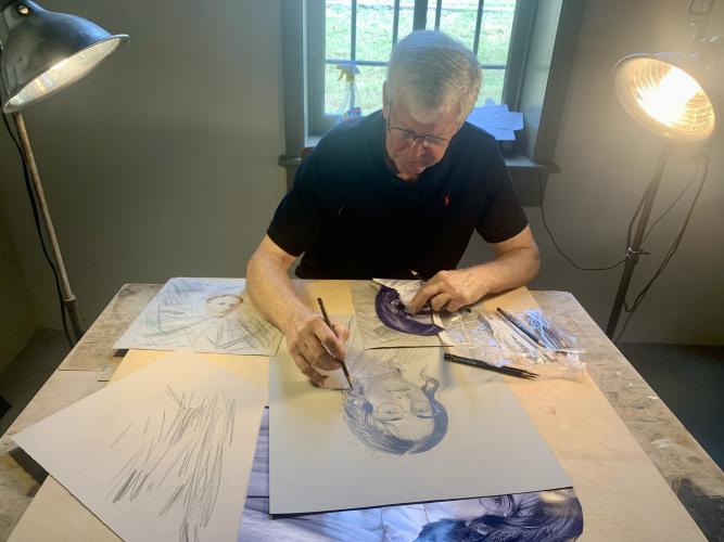 Illustrator John Fortuna works on a new drawing during the Art Crawl at the Historic Oglethorpe County Jail on Oct. 8, 2022. (Photo/Nimra Ahmad)