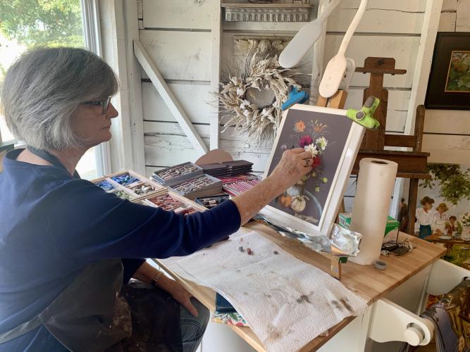 Artist Mary Ann Cox, who works on a new pastel still-life at her studio during the Art Crawl, took advantage of the event to meet new folks.