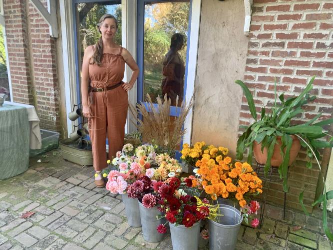 Jenny DeRevere poses with freshly harvested flowers at her home on Oct. 8, 2022. (Photo/Nimra Ahmad)