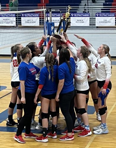 Oglethorpe County volleyball team members hoist their area championship trophy after defeating Aquinas in the title match last Thursday. (Photo/Maggie Ruland)