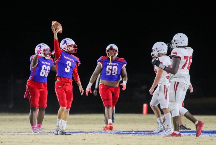 OCHS quarterback Will Sampson holds football high after regaining the ball from a Social Circle interception. OCHS homecoming game, Friday, Oct. 28, 2022. (Aisha Schulz/The Oglethorpe Echo)