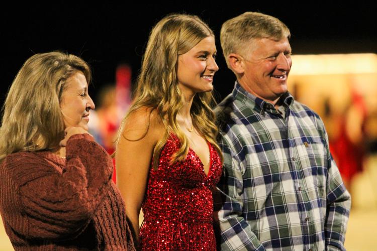 Lizzie Wadsworth poses with her parents, Mary and Robert Wadsworth for senior night photos. OCHS homecoming game, Friday, Oct. 28, 2022. (Aisha Schulz/The Oglethorpe Echo)