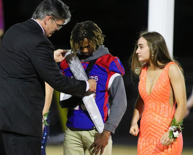 Michael Fleming (center) is crowned Mr. Senior Class by Sr. Brian Lance. Andi-Grace Moore also pictured. OCHS homecoming game, Friday, Oct. 28, 2022. (Aisha Schulz/The Oglethorpe Echo)