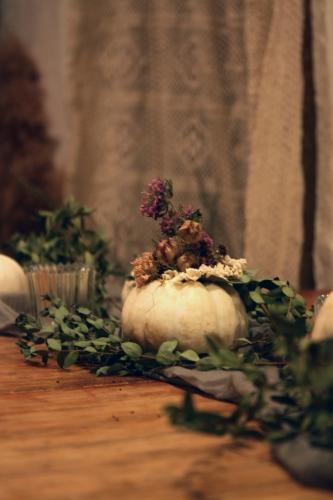 Floral artist Jenny Derevere adds both homegrown and foraged dried Nigella, Monarda, snapdragon and Scabiosa, or pincushion flower, to a white pumpkin for a twist on natural fall decor. She uses blossom from her flower farm in Stephens. (Photo/Isabelle Manders)