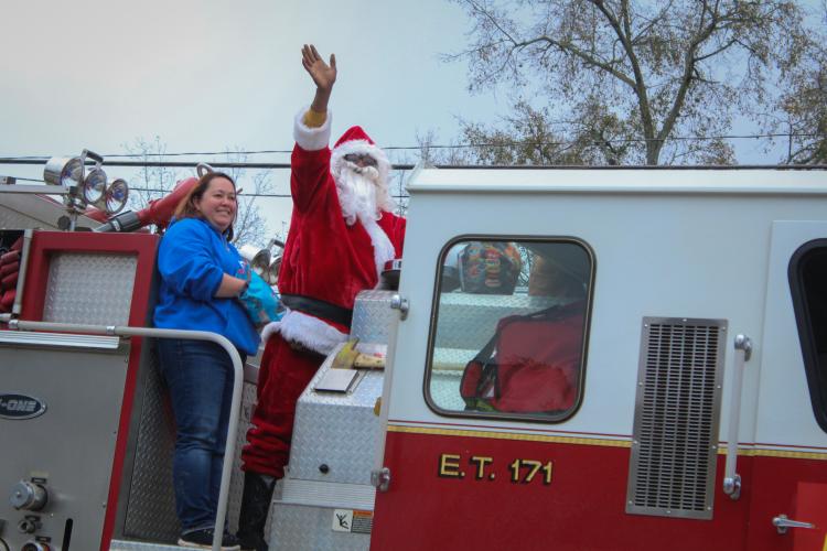 Santa waves to the crowd of people watching the War Room Show's community Christmas parade in Crawford, Georgia on Saturday, December 10, 2022. (Photo/ Basil Terhune)