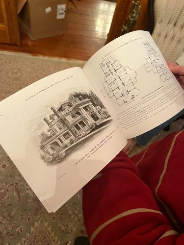 Tom Sheridan shows his copy of “Barber’s Turn-of-the-Century Houses,” a book that home and floor plans from houses built in the early 1900s. (PEYTON JENKINS/THE OGLETHORPE ECHO) 