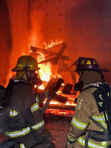 Volunteer firefighters-in-training take part in a live burn test on Saturday, Dec. 3. The live burn test, where firefighters must put out a fire in a controlled environment, is a requirement to become certified. (Photo/submitted)