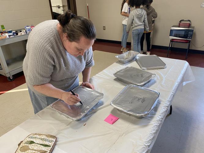 Amber Waldroup, who started at the UGA Extension Office last September, labels dishes at a recent Cooking to Share Program. (ERIN KENNEY/THE OGLETHORPE ECHO)
