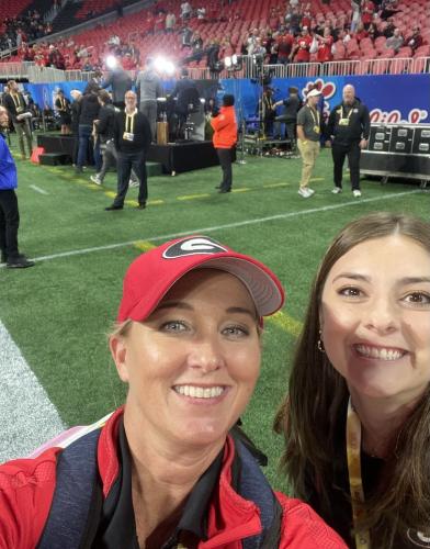 Katy Wilkins (left) and Braelynn Neely snap a selfie in front of the College Game Day set at the Peach Bowl. Neely and Wilkins work for the Redcoat Band Auxiliary Unit. (Submitted Photo)