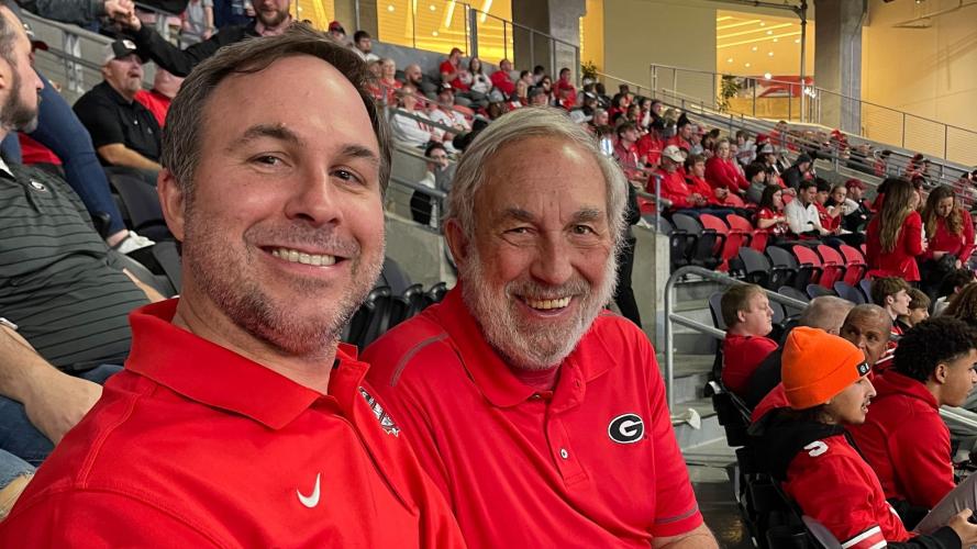 Warren Gilson (right), the mayor of Maxeys, and his son Wesley Gilson attended the Peach Bowl at Mercedes-Benz Stadium on Saturday. Georgia defeated Ohio State 42-41 to advance to the CFP National Championship game. (Submitted Photo)