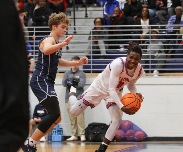 OCHS's Jaelin Lumpkin struggles to keep his possession inbounds during the Patriots' game against Prince Avenue. (Photo/Emily Dozier)