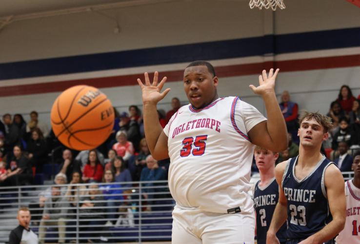 Kb Bonds, senior, raises his hands to signal a no-touch during Oglethorpe County's basketball game against Prince Avenue. The Patriots defeated the Wolverines 49-46 in the region matchup. (Photo/Emily Dozier)