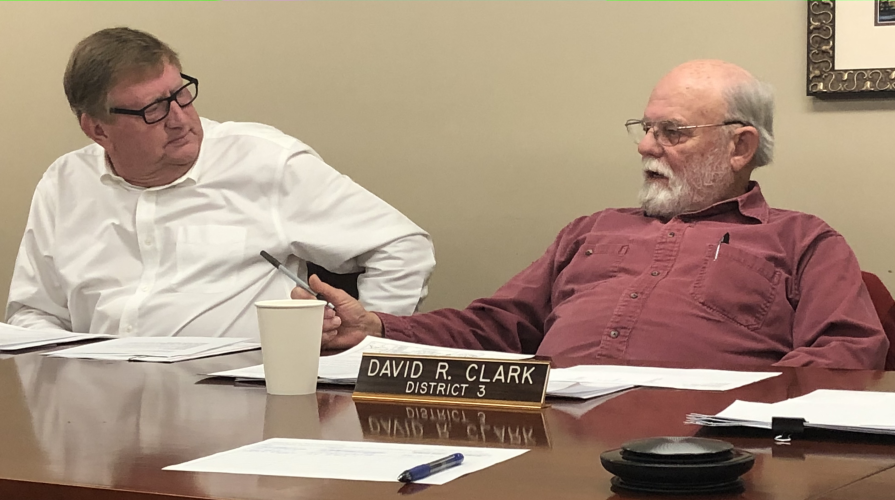 (ANDY JOHNSTON/THE OGLETHORPE ECHO) Commissioners Andy Saxon and David Clark discuss issues during the Board of Commissioners meeting on Monday night. The board passed a resolution stating the county's position on soil amendments.