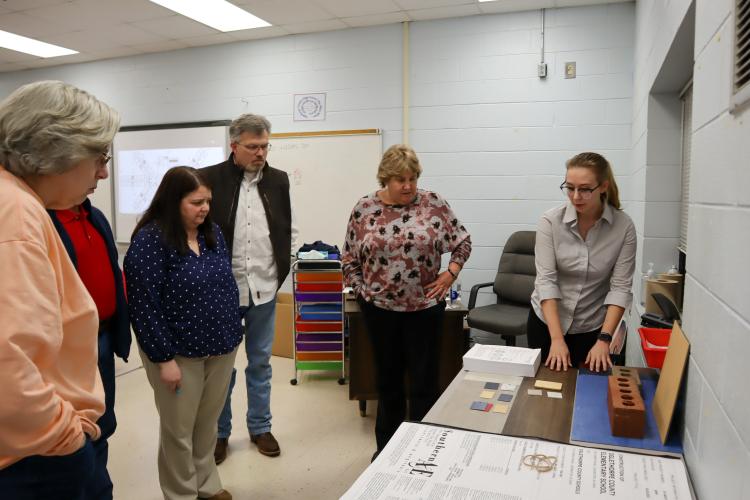 Southern A&E architect Sara Honeycutt shows materials and decor examples to Superintendent Beverley Levine and Board of Education members at the meeting on Tuesday. Honeycutt explained the color choices and how they will be applied. (Photo/Viktoria Kangas)