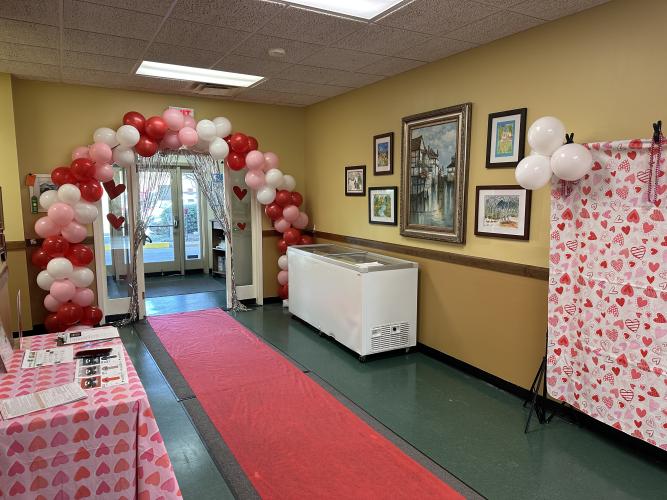 The Valentine's Ball decorations upon entry in the Oglethorpe County Senior Citizen's Center on Tuesday. The decor features a balloon arch, a red carpet, and a Valentine's Day themed photo wall. (Photo/Gianna Rodriguez)