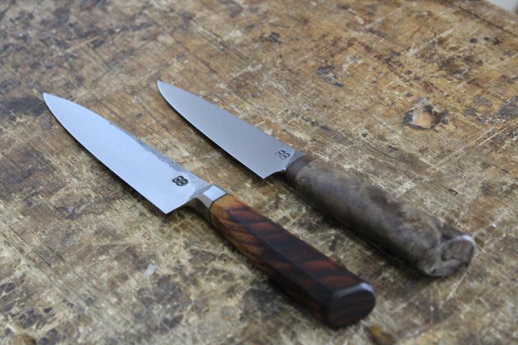 Finished knives left to right: Octagonal integral petty knife with a scorched osage orange handle and roller bearing steel. Petty knife with Blackwood faceplate (sourced scrap from a clarinet factory in Paris) and black-dyed maple burl handle. The maple burl is from a tree harvested on Bloodroot Blades' property and steel is roller bearing steel. (Photo/Sarah Donehoo)
