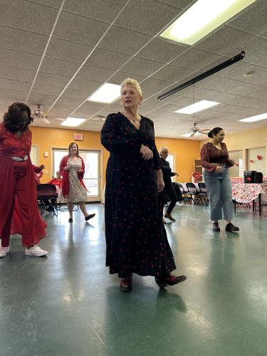 Marty Green helps teach a line dance on February 14, 2023. The line dancing encouraged a lot of involvement at the Valentine's Ball. (Photo/Shelby Wingate)